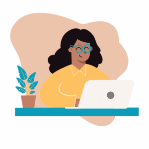 Person sitting at a desk with a computer in front of them. They are smiling.