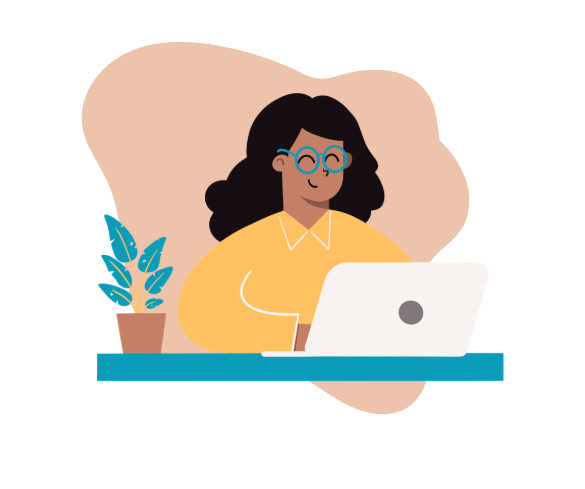 Person sitting at a desk with a computer in front of them. They are smiling.